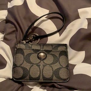 Black and grey Coach key chain wallet.